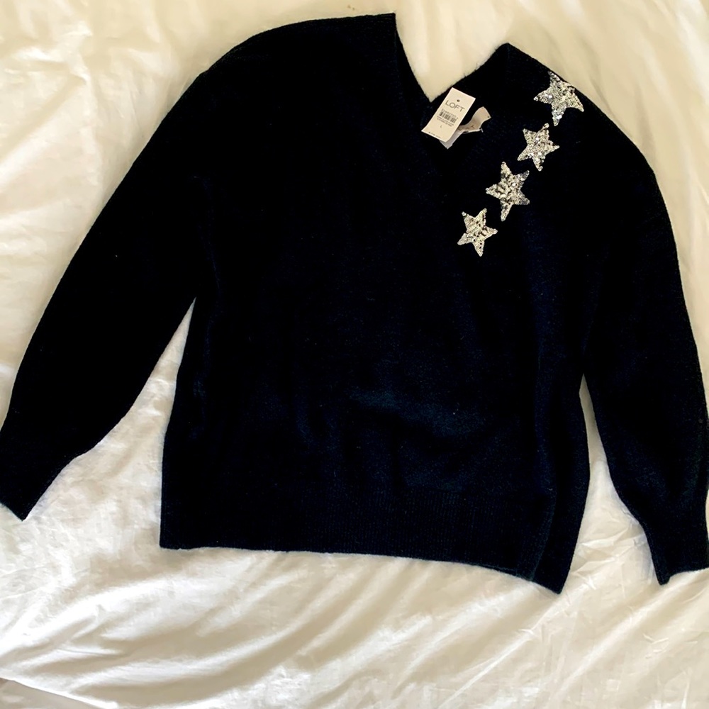 Black sweater with silver stars. Beautiful and never worn.